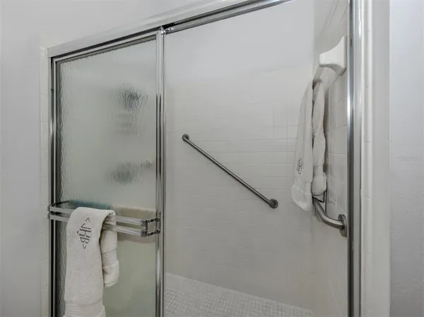 a bathroom with a glass shower door