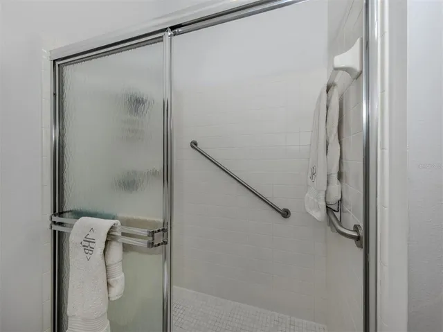 a bathroom with a glass shower door