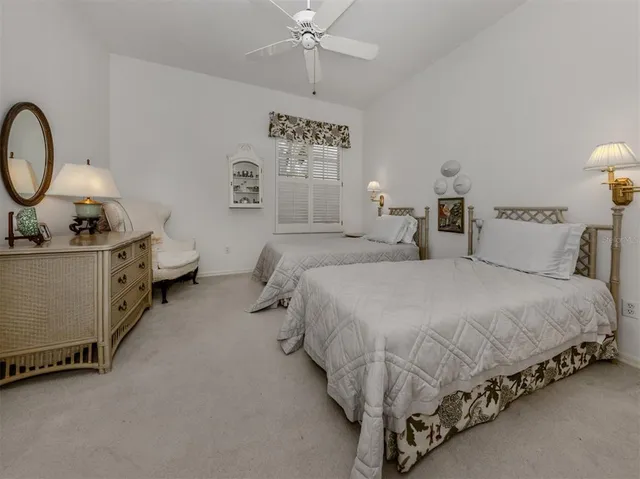 a spacious bedroom with a bed and a chandelier