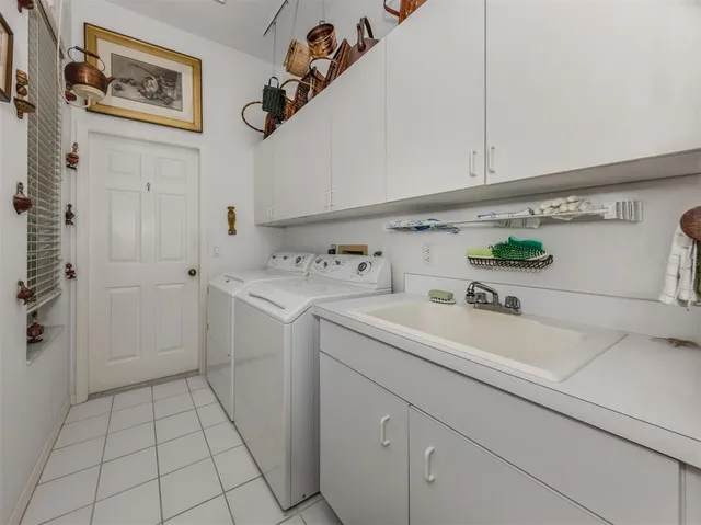 a utility room with a sink dryer and washer