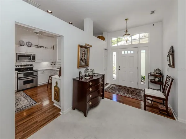 a kitchen with appliances a sink and cabinets