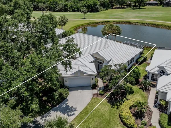 an aerial view of a house with a yard