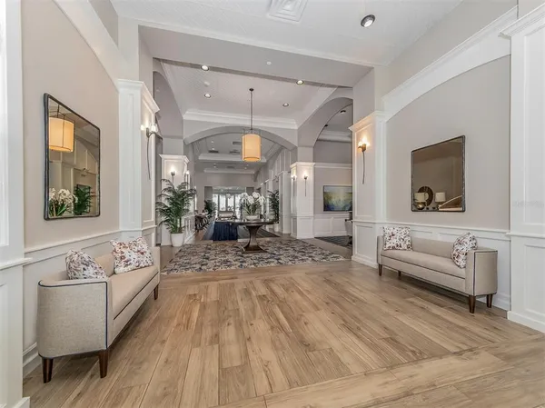 a living room with lots of furniture and a large window