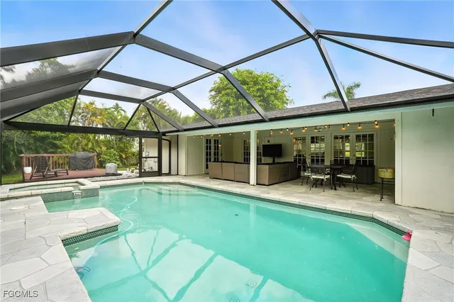 a house view with swimming pool in front of it