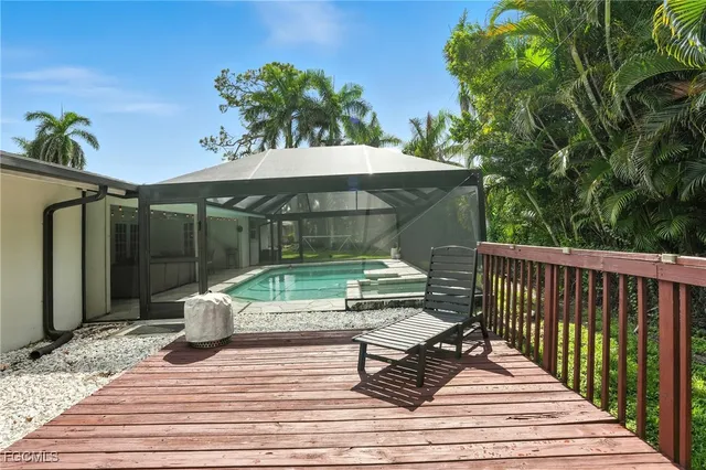 a view of backyard with deck and outdoor seating