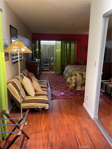 a bed sitting in a bedroom next to a lamp