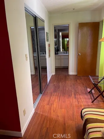 a bathroom with a granite countertop sink a toilet and a mirror