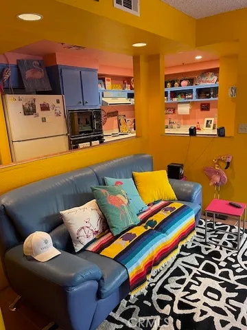 a living room with blue lights with furniture and fish tank