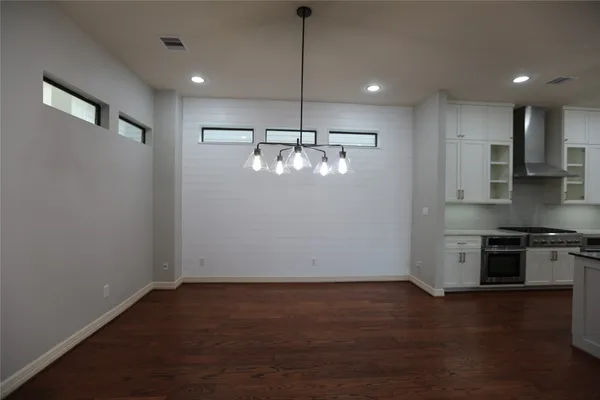 a view of a kitchen with stainless steel appliances granite countertop cabinets and wooden floor