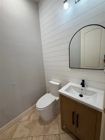 a bathroom with a sink a toilet and mirror