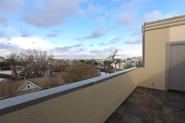 a view of balcony with furniture and city view