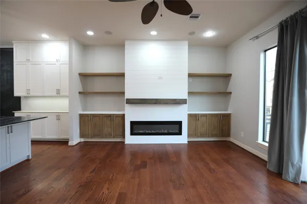 a open kitchen with a refrigerator and a stove top oven