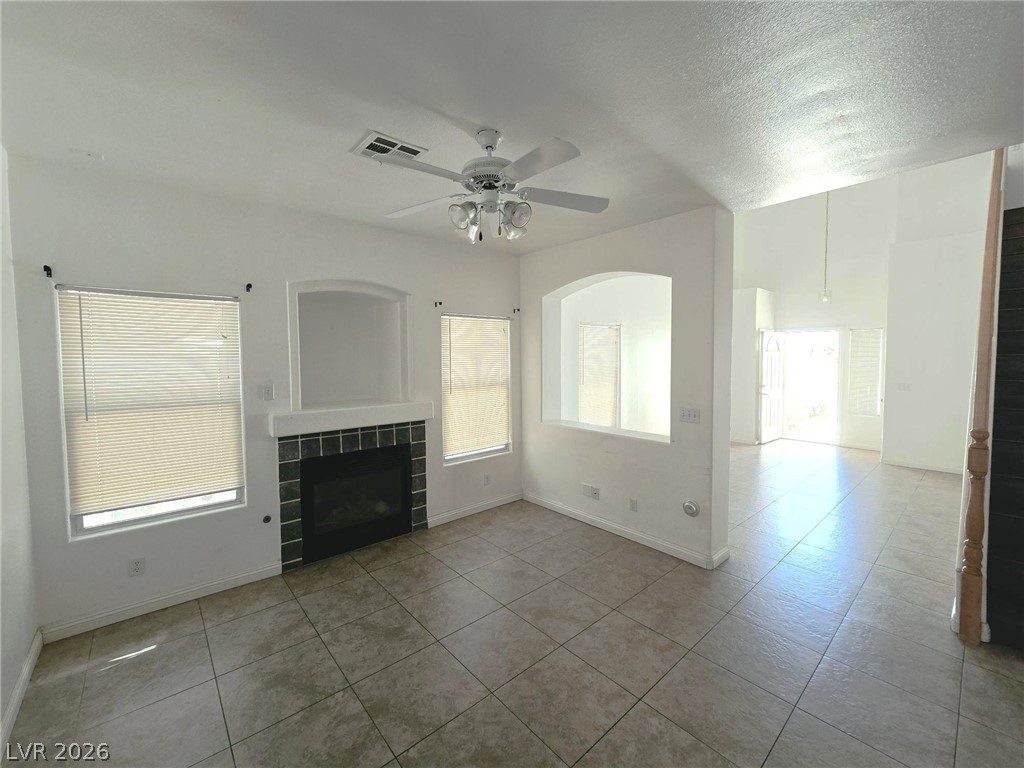 9034 West Rochelle Avenue Las Vegas, NV 89147 - Photo 3 of 8 A well-lit living area showcases a sleek fireplace and ample room for gatherings.