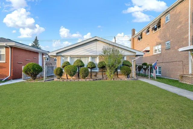 a view of a house with a yard porch and sitting area