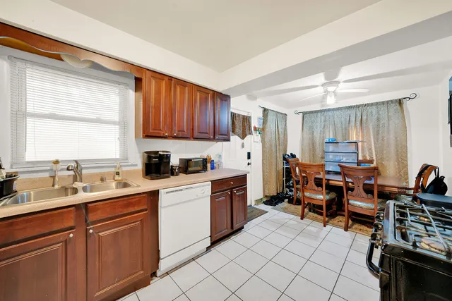a kitchen with a sink window and cabinets