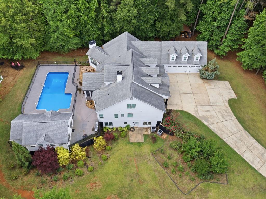 582 Knox Chapel Road Social Circle, GA 30025 - Photo 2 of 49 an aerial view of a house with a yard and trees all around