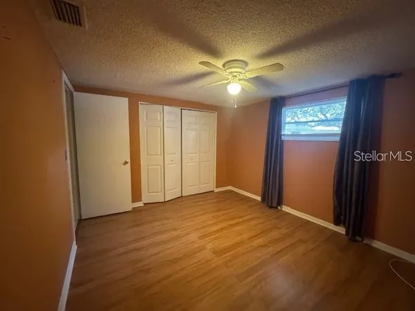 a view of an empty room with a ceiling fan