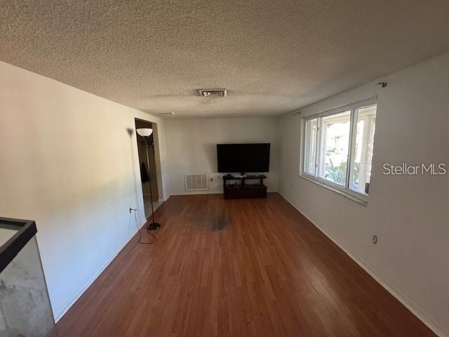 7235 Redbud Court New Port Richey, FL 34653 - Photo 7 of 9 a view of empty room with wooden floor and fan