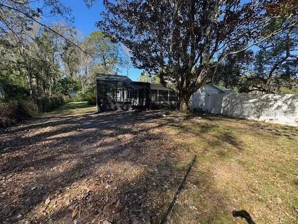 a view of a backyard with large trees