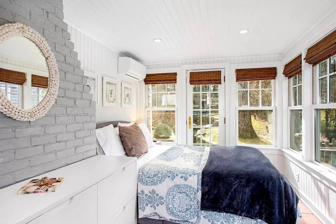 3752 Noyack Road Sag Harbor, NY 11963 - Photo 10 of 17 a bedroom with a bed and a large window