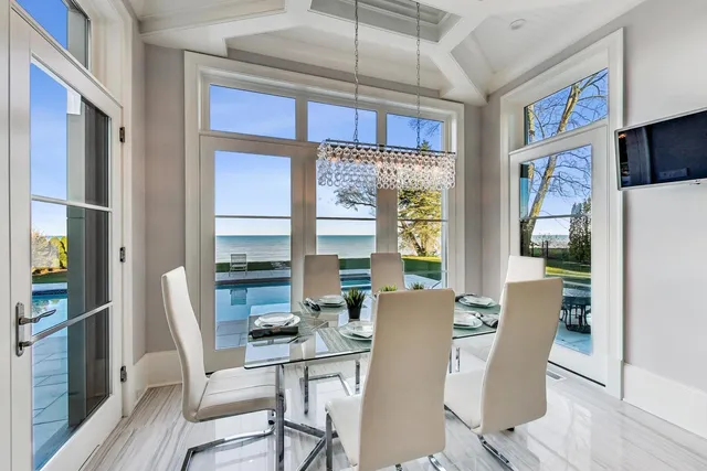a living room with fireplace furniture and a chandelier