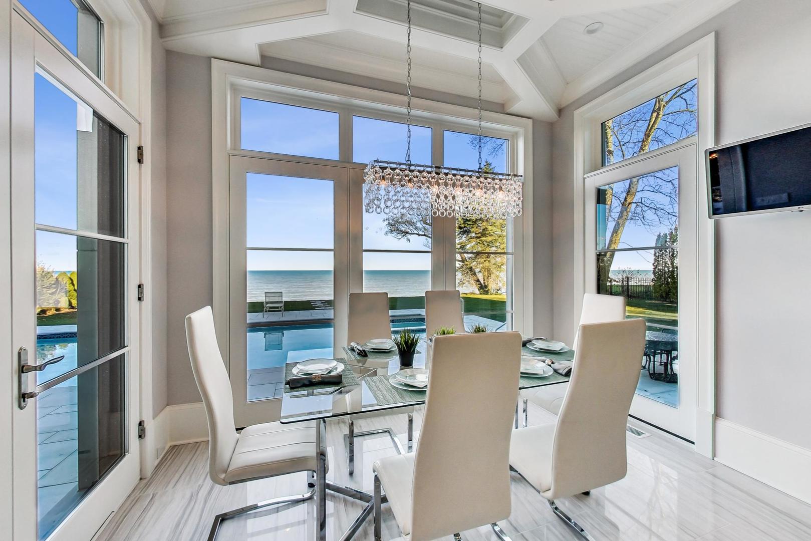 501 Sheridan Road Kenilworth, IL 60043 - Photo 14 of 20 a dining room with furniture a flat screen tv and outdoor view