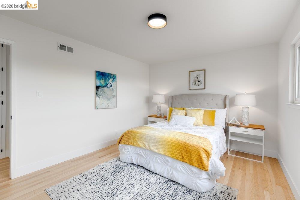 1298 Ribbon Street Foster City, CA 94404 - Photo 50 of 86 Bright bedroom featuring light wood-finish flooring, white walls, a single window, and a modern ceiling light fixture