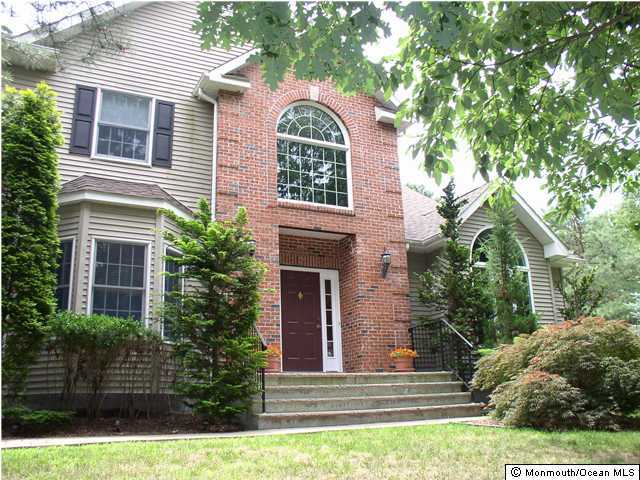 3 Applegate Road Clarksburg, NJ 08510 - Photo 1 of 3 a view of a brick house with plants and large trees