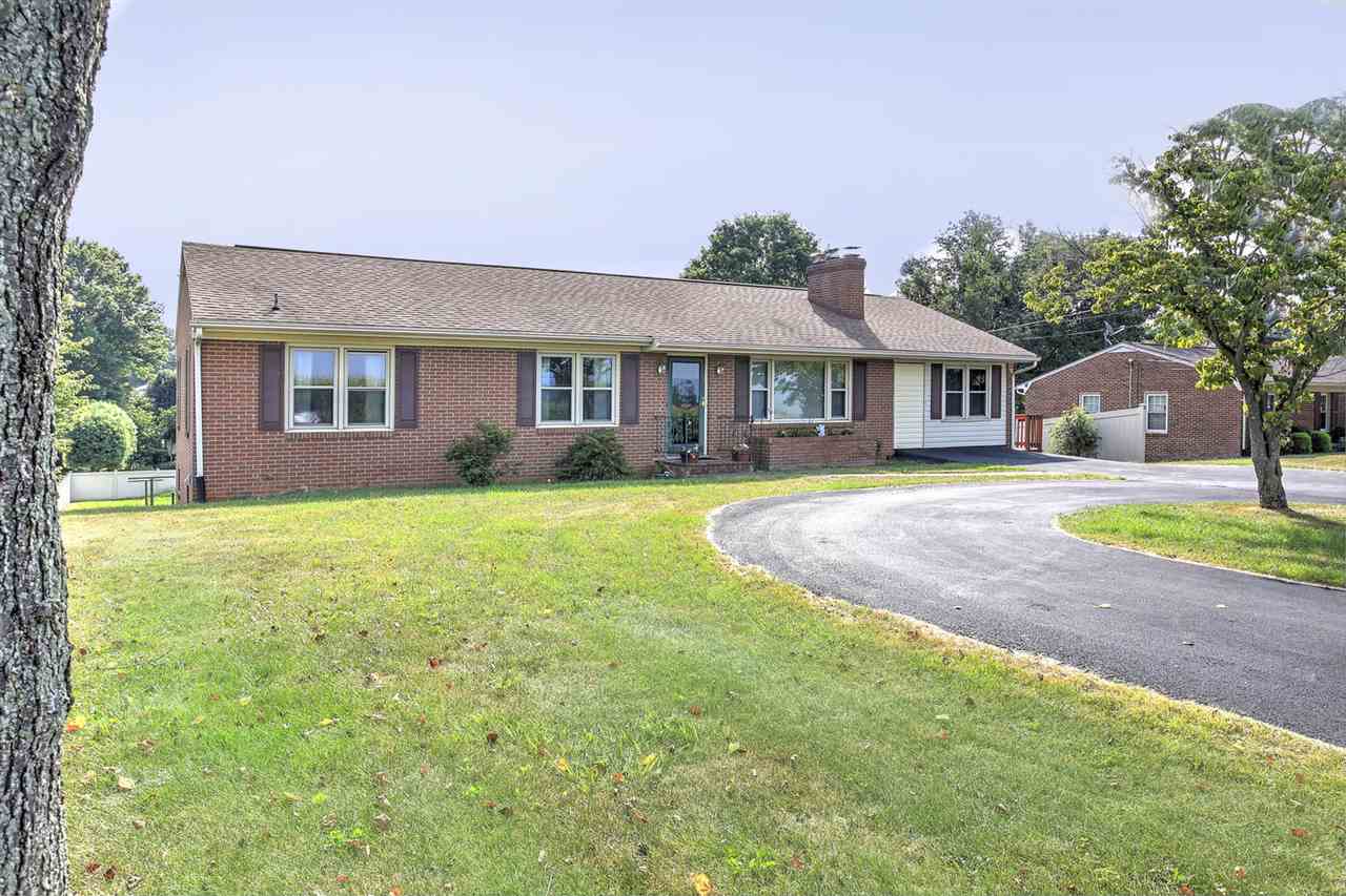 1050 Ladd Road Waynesboro, VA 22980 - Photo 3 of 33 a front view of a house with a garden and yard