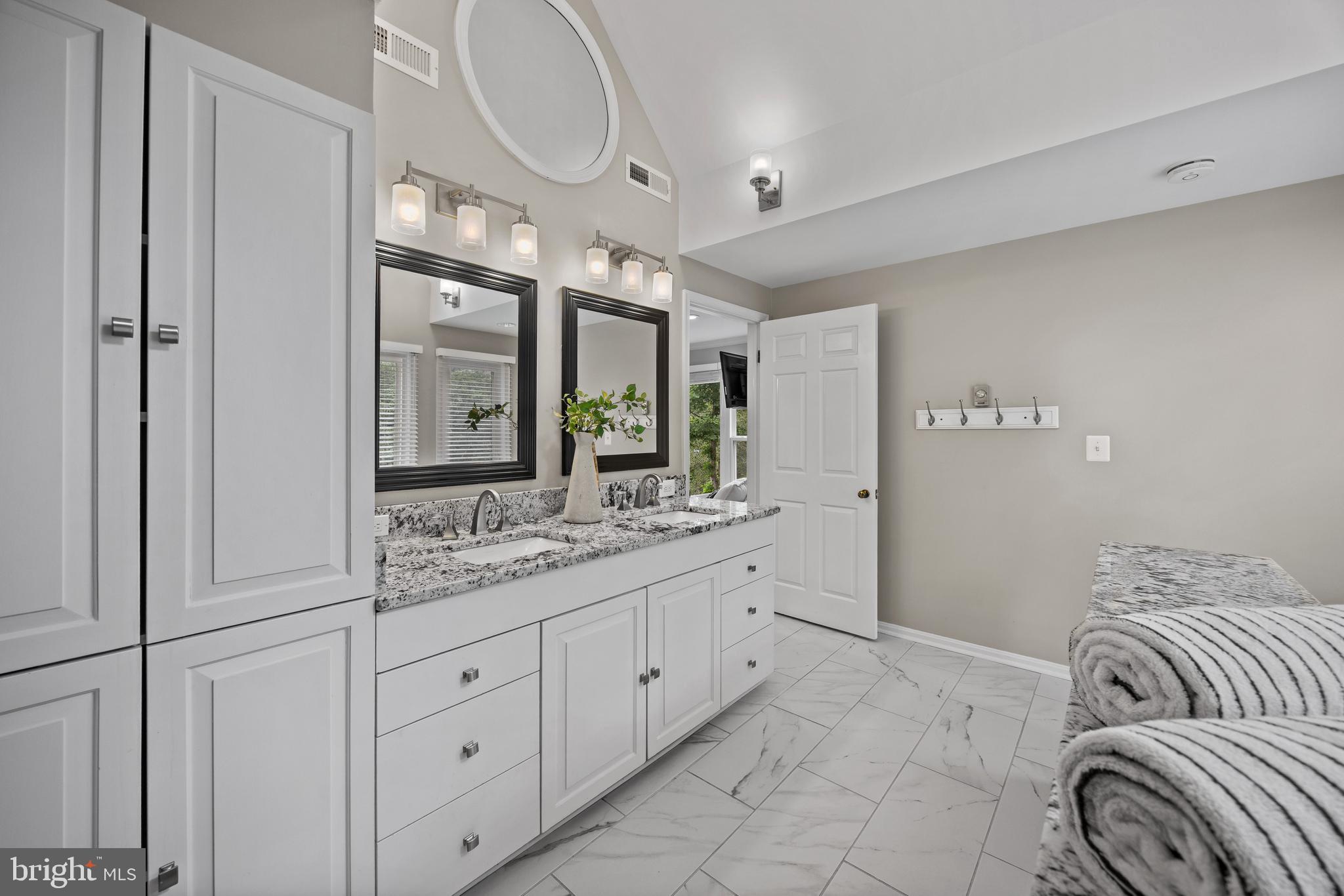 3484 Olympia Road Davidsonville, MD 21035 - Photo 28 of 50 a spacious bathroom with a double vanity sink a mirror and a shower
