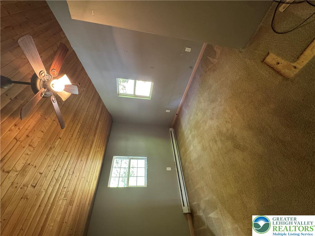 134 Bear Road Kunkletown, PA 18058 - Photo 30 of 42 A vaulted wood-paneled ceiling highlights this room with soft carpeting and natural light.