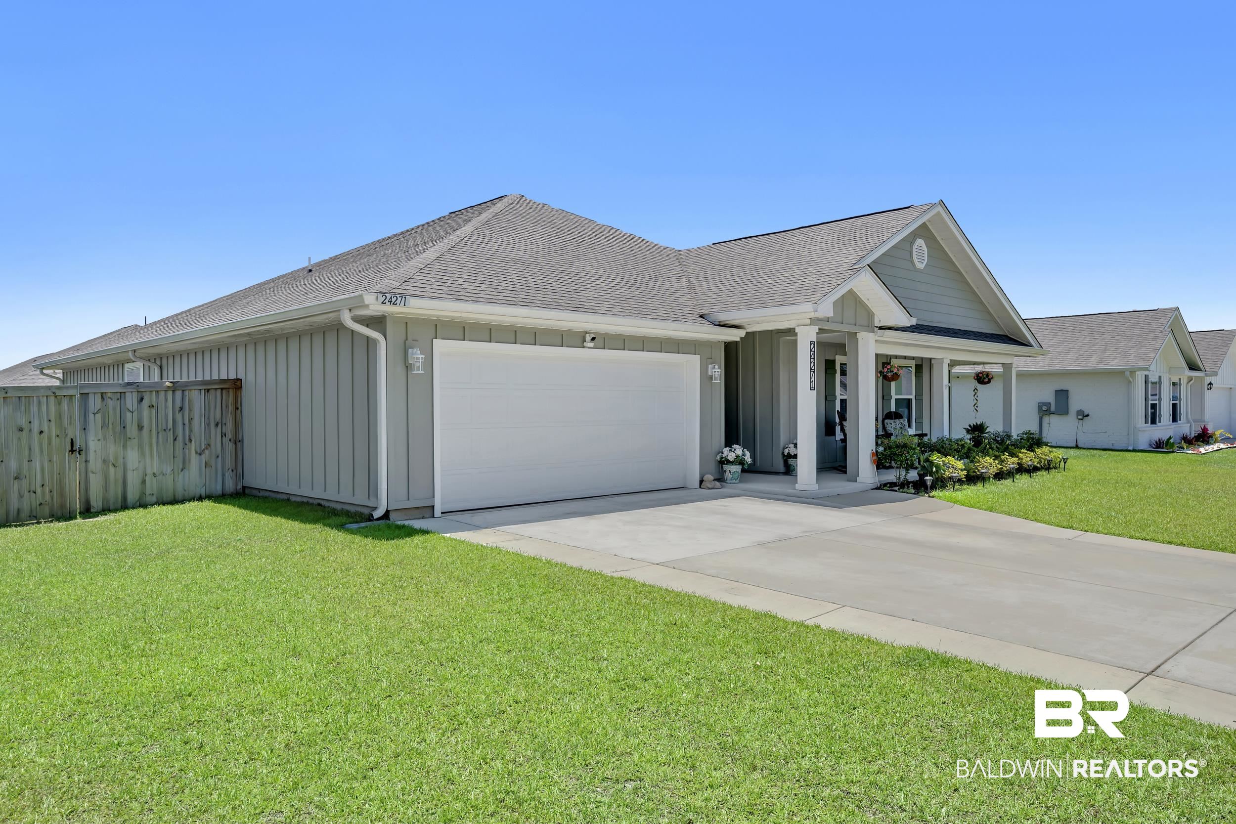 24271 Ringneck Loop Elberta, AL 36530 - Photo 37 of 44 Single-story residence featuring a covered front porch with white columns, light gray siding, and a two-car garage