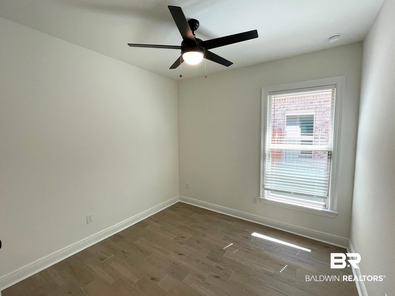 1565 Fenton Circle Foley, AL 36535 - Photo 11 of 15 Unfurnished room with ceiling fan and hardwood / wood-style flooring