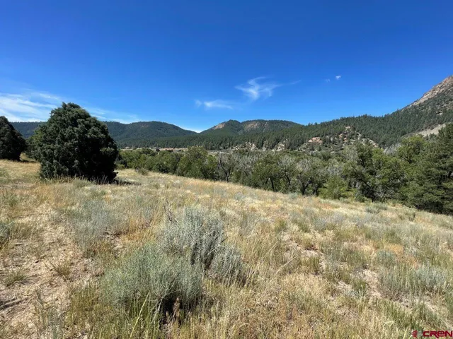 a view of a road with mountains in the background