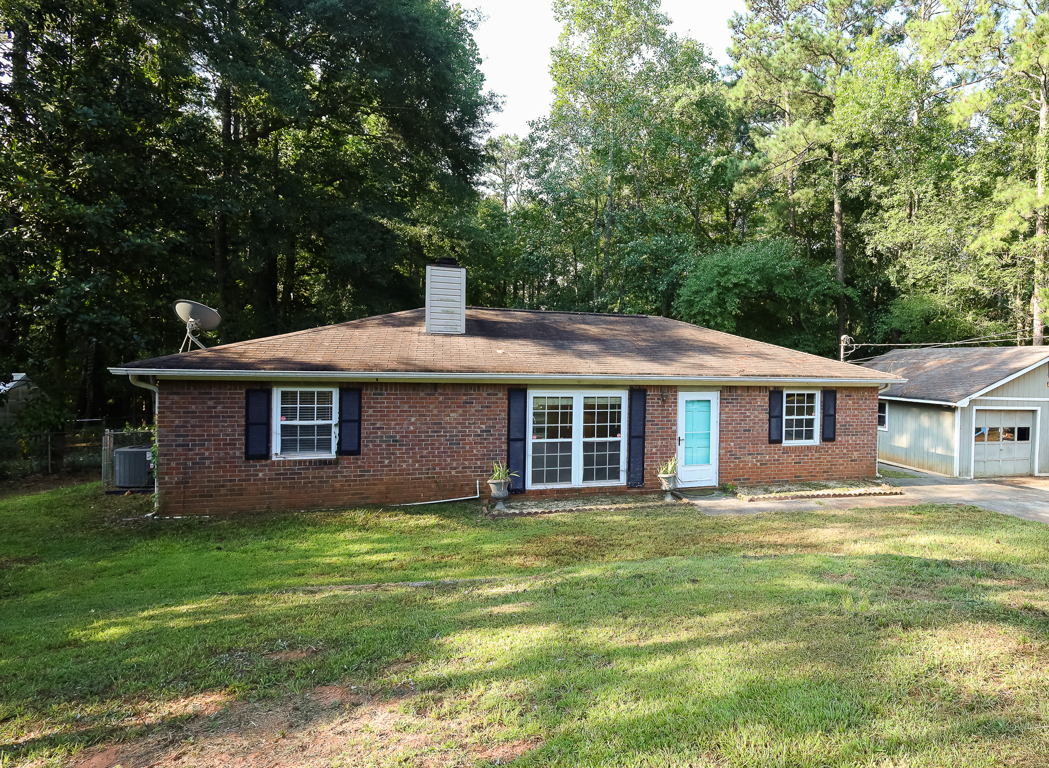 1168 Country Club Road Newnan, GA 30263 - Photo 1 of 1 a brick house that is sitting in the grass
