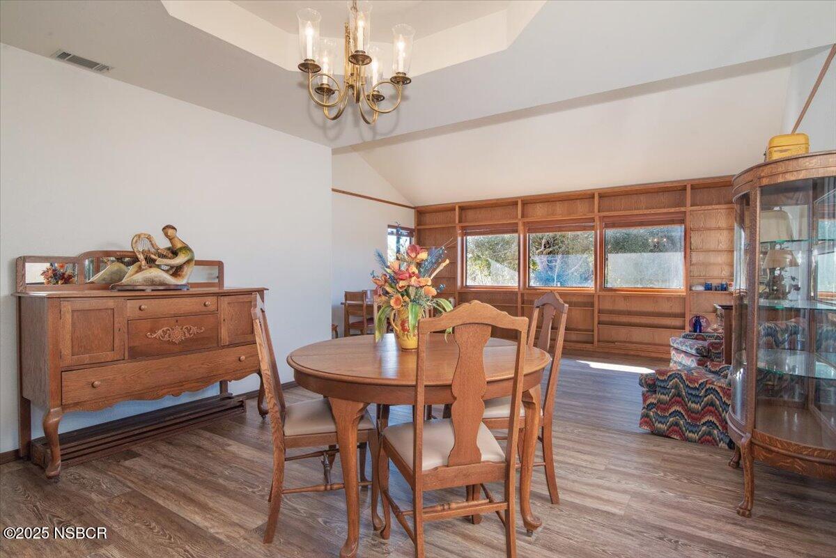 628 St Andrews Way Lompoc, CA 93436 - Photo 16 of 36 a dining room with furniture a chandelier and wooden floor