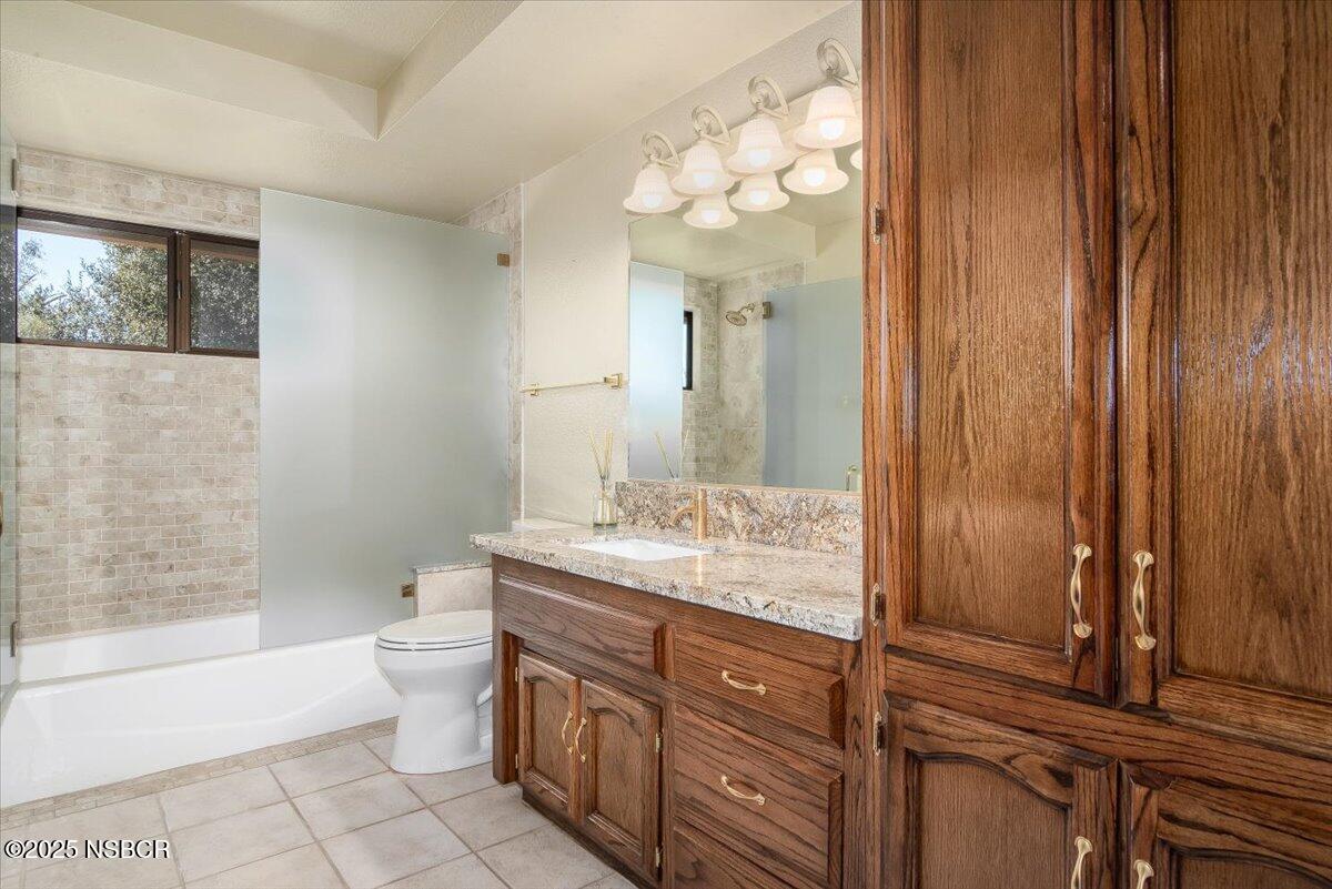 628 St Andrews Way Lompoc, CA 93436 - Photo 17 of 36 a bathroom with a granite countertop sink toilet and shower