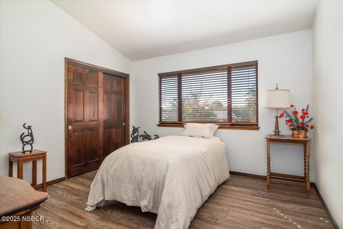 628 St Andrews Way Lompoc, CA 93436 - Photo 21 of 36 a bedroom with a bed and a table