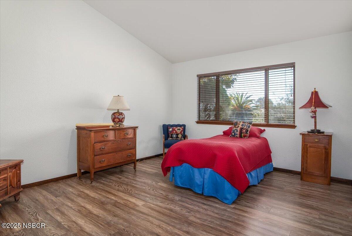 628 St Andrews Way Lompoc, CA 93436 - Photo 22 of 36 a bedroom with a bed and wooden floor