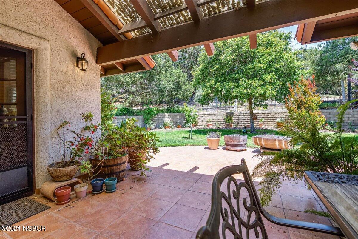 628 St Andrews Way Lompoc, CA 93436 - Photo 27 of 36 a patio with table and chairs and potted plants