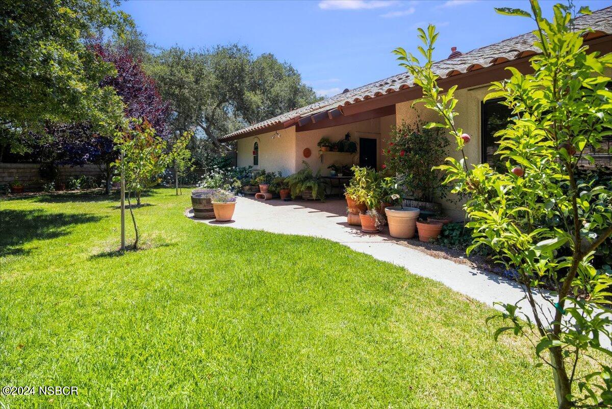 628 St Andrews Way Lompoc, CA 93436 - Photo 29 of 36 a view of a house with backyard and a tree