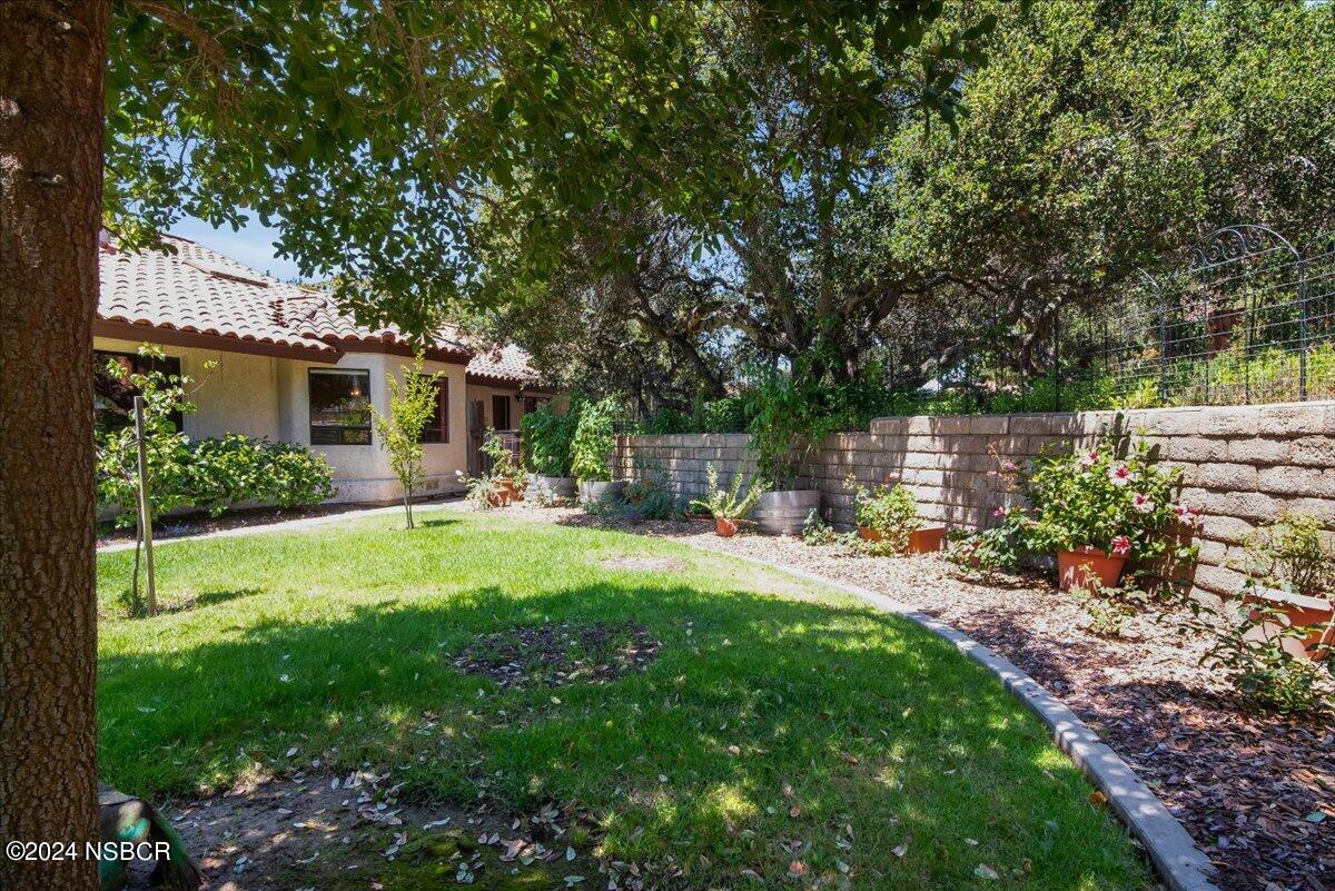 628 St Andrews Way Lompoc, CA 93436 - Photo 30 of 36 a view of backyard of house with green space and seating area