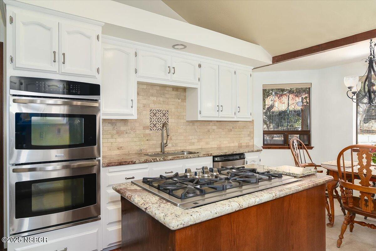 628 St Andrews Way Lompoc, CA 93436 - Photo 5 of 36 a white stove top oven sitting inside of a kitchen