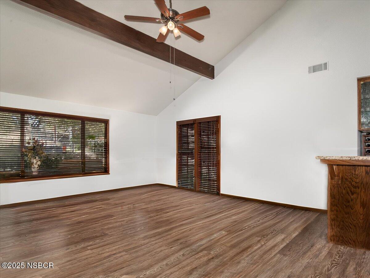 628 St Andrews Way Lompoc, CA 93436 - Photo 10 of 36 a view of an empty room with wooden floor and a window