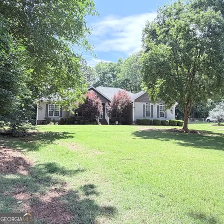 a front view of house with yard and trees