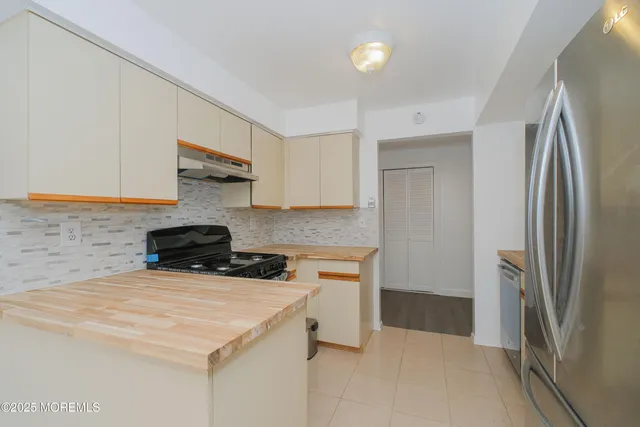 a kitchen with a stove a refrigerator and a sink