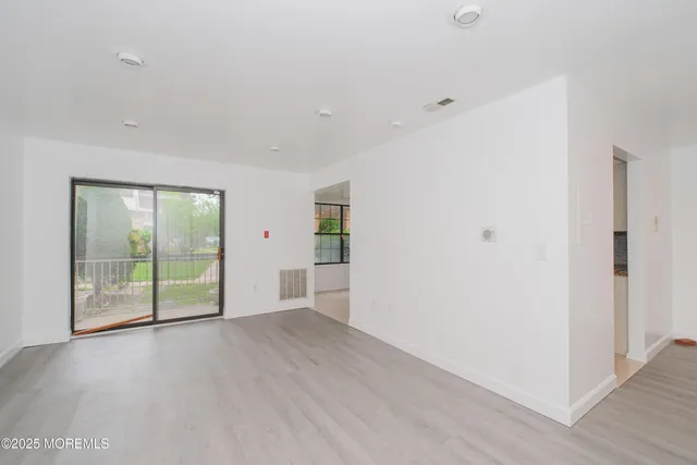 a view of an empty room with glass door