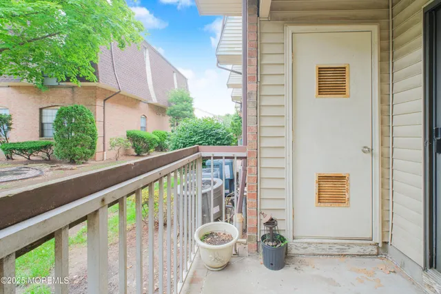 a view of a balcony with chair and potted plants
