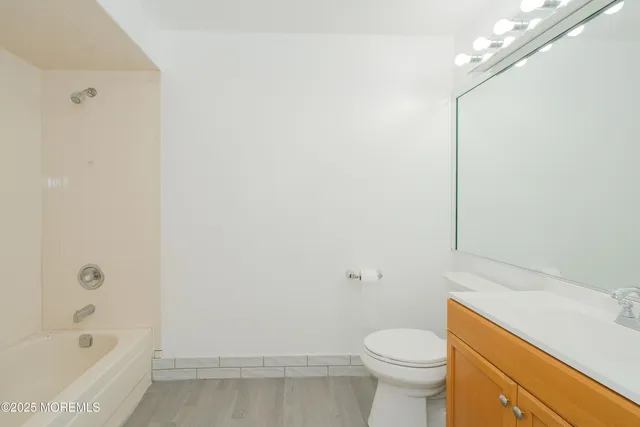 a white toilet sitting next to a bath tub