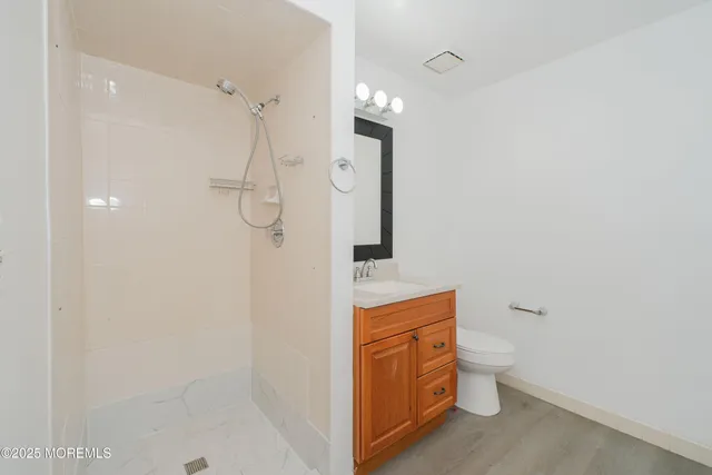 a bathroom with a toilet sink and shower
